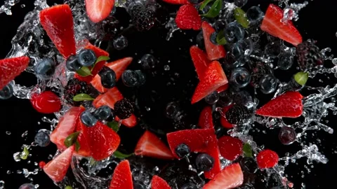Super slow motion shot of rotating exploded berries fruit with splashing water Video stock 171836841