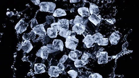 Super slow motion shot of rotating exploded Ice Cubes and splashing water on Video stock 171909729