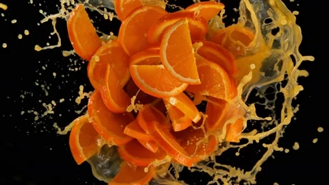 Super slow motion shot of rotating exploded orange slices with splashing juice 스톡 동영상 171910914