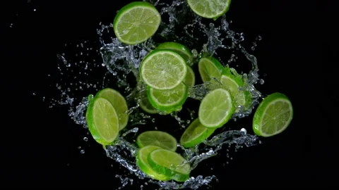 Super slow motion shot of rotating exploded lime slices with splashing water on Video stock 173045942