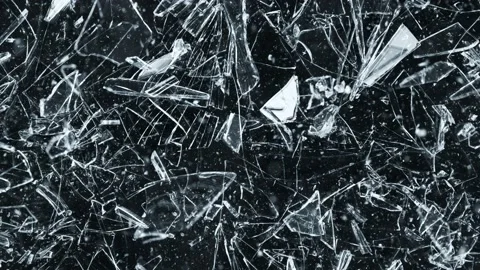 Super Slow Motion Shot of Shattering Glass Shards Flying Towards Camera on Black Stock Footage 221975985