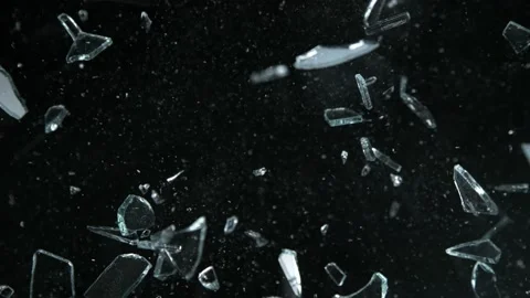 Super Slow Motion Shot of Shattering Glass Shards Flying Towards Camera on Black Stock Footage 224064361