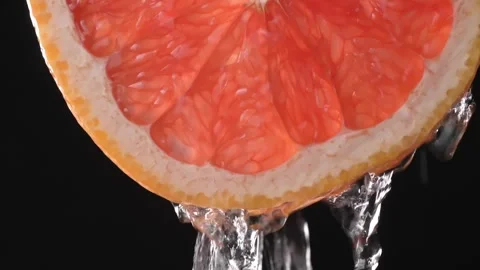 Super slow motion shot of sliced slice of grapefruit with splashes of water, Stock Footage 248785147