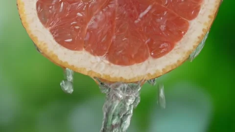 Super slow motion shot of sliced slice of grapefruit with splashes of water, Stock Footage 248785255