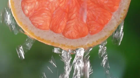 Super slow motion shot of sliced slice of grapefruit with splashes of water, Stock Footage 248786233