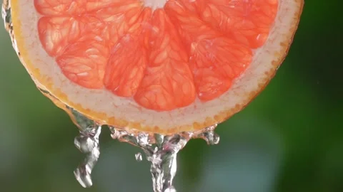 Super slow motion shot of sliced slice of grapefruit with splashes of water, 스톡 동영상 248894850