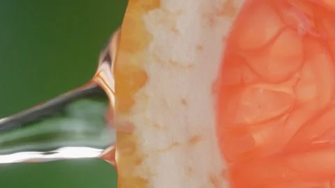Super slow motion shot of sliced slice of grapefruit with splashes of water, Stock Footage 251914676