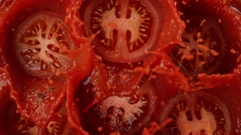 Super Slow Motion Shot of Tomato Cuts Falling and Splashing into Sauce, 1000fps Video stock 293719528