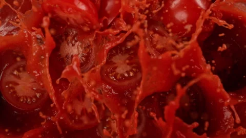 Super Slow Motion Shot of Tomato Cuts Falling and Splashing into Sauce at Stock Footage 298740452