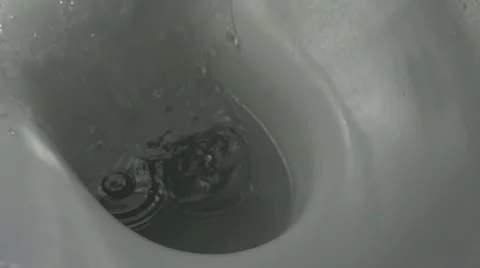 Super slow motion shot of water being flushed in a toilet bowl, 500 fps Stock Footage