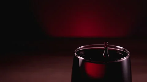 Super Slow Motion Shot of Wine Drop Falling into Red Wine in Glass at 1000fps. Stock Footage 160674854