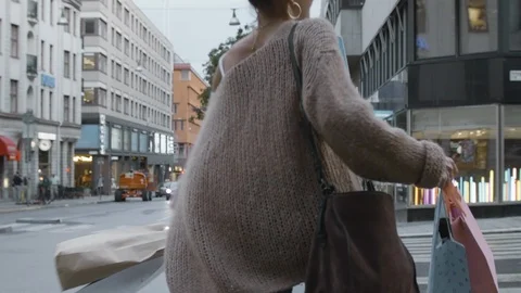 Super slow motion shot of a young woman spinning around with her shopping bags Stock Footage 117237626
