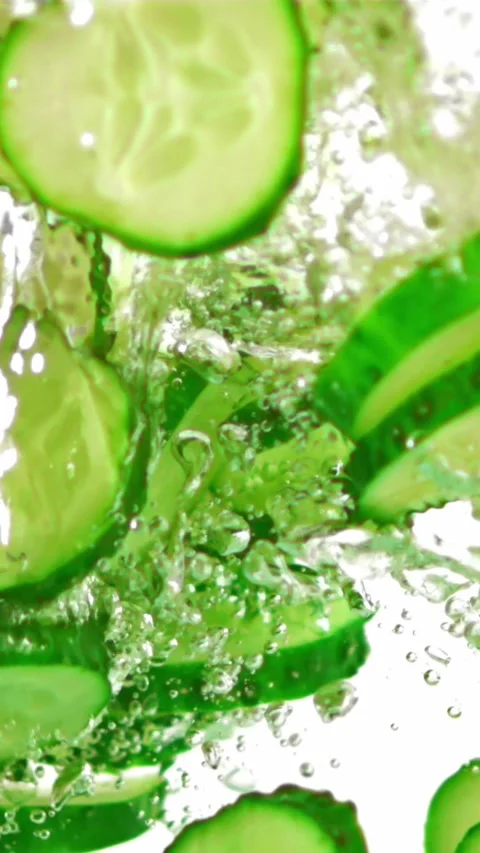 Super slow motion sliced fresh cucumber under water with air bubbles. Filmed on Stock Footage 335288622