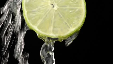 Super slow motion of sliced lime slices with splashes of water, Stock Footage 248789704