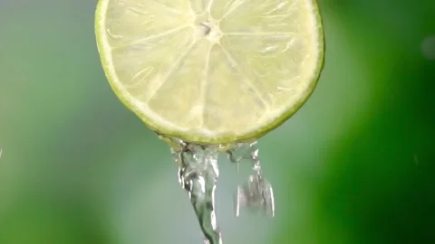 Super slow motion of sliced lime slices with splashes of water, Stock Footage 248898472