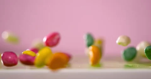 Super Slow Motion Slowmotion Capture Of Colorful Candies Bouncing On Pink Stock Footage 333485221