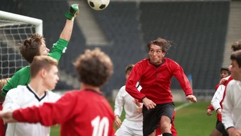Super slow motion soccer player headers ball into goal during football match Video stock 80516577