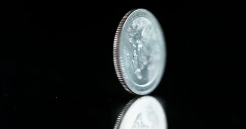 Super slow motion spinning US quarter coin Stock Footage