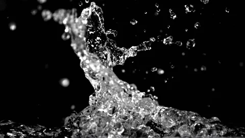 Super slow motion splashes water on a black background. Filmed on a high-speed Stock Footage 153108941