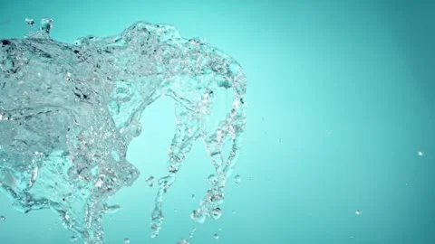 Super slow motion of splashing water isolated on blue background. Stock Footage 265189657