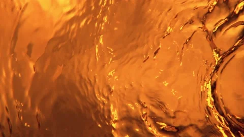 Super slow motion of splashing whiskey, cognac or oil surface. Stock Footage 209304763