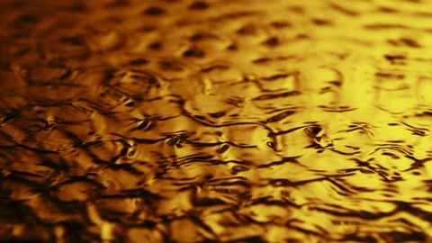 Super slow motion of splashing whiskey, coffee or oil surface. Stock Footage 280294232