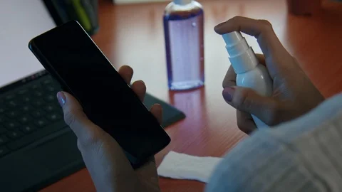 Super Slow Motion Spray Bottle Disinfectant on Phone Screen Stock Footage 128163148