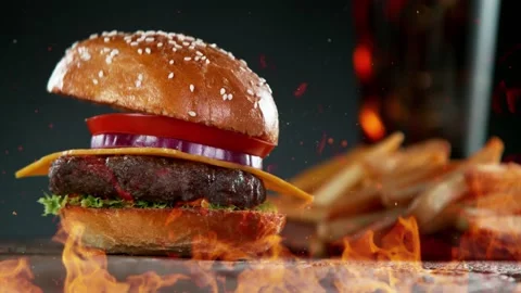 Super slow motion of stacking hamburger pieces with fire. Stock Footage 211704222