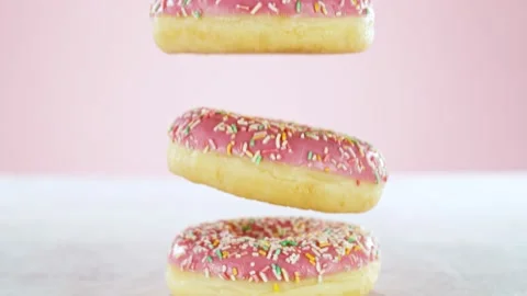 Super slow motion of stacking sweet donuts pieces Stock Footage 238441006