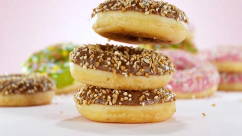 Super slow motion of stacking sweet donuts pieces Stock Footage 238441018