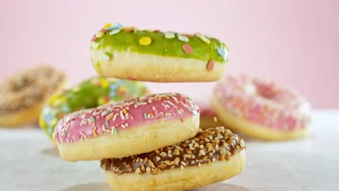Super slow motion of stacking sweet donuts pieces Stock Footage 238441054