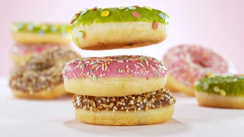 Super slow motion of stacking sweet donuts pieces Stock Footage 243021258