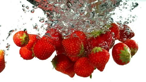 Super slow motion of strawberries falling into water, speed ramping effect Stock Footage 118977448