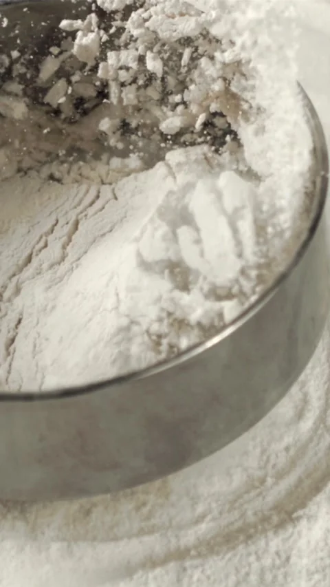 Super slow motion on the table with flour falling sieve. Filmed on a high-speed Stock Footage 335287471