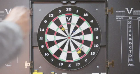 Super slow motion throwing dart and hitting bullseye on target Stock Footage 230985481