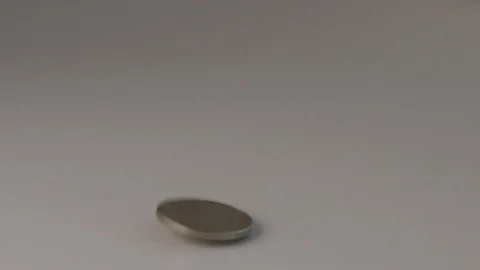 Super slow motion of US coins falling on a table Stock Footage 117626562