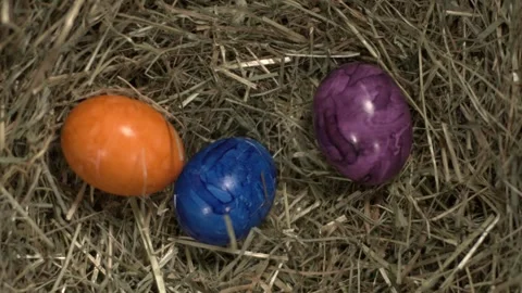 Super Slow Motion Vibrant Painted Eggs Rest In Hay, Small Colorful Eggs In Stock Footage 327096474