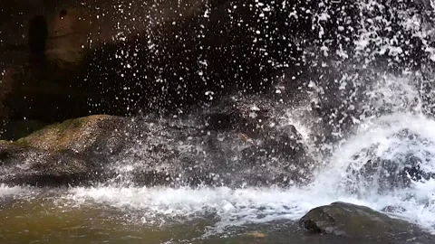Super slow motion waterfall front of cave Stock Footage 138752292