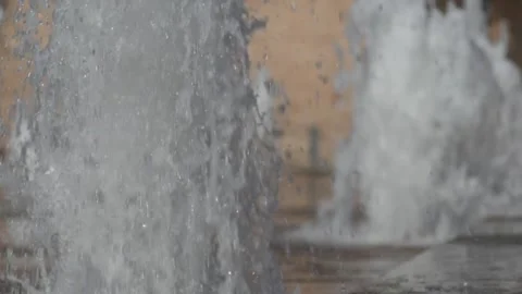 Super slow motion of waters jets installed on the floor of a square. Stock Footage 336364487