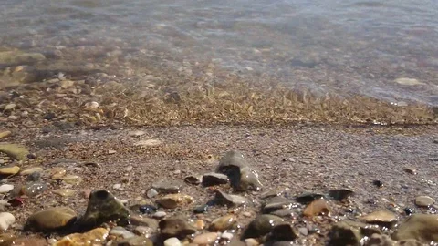 Super slow motion wave at closeup of a stony beach. Stock Footage 120412447