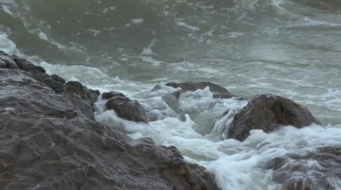 Super Slow Motion Waves breaking over rocks on beach Video stock 11407821