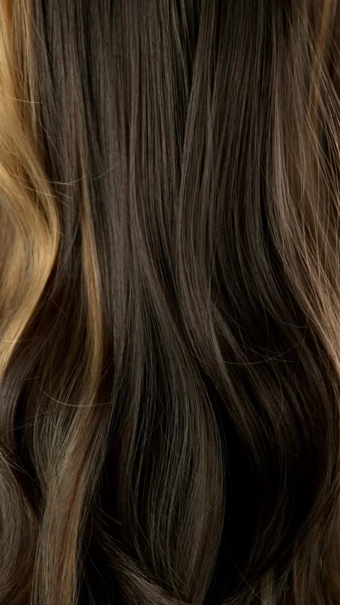 Super slow motion of wavy brown hair in detail. Stock Footage 298711092