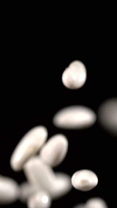 Super slow motion, White Beans Floating In Black Studio Chef Experiments Stock Footage 330273497