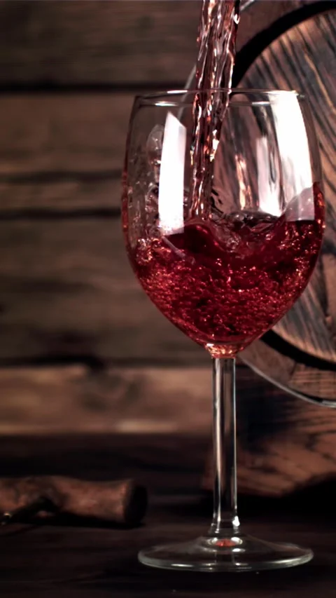 Super slow motion wine pours into a glass of air bubbles. Filmed on a high-speed Stock Footage 335286748