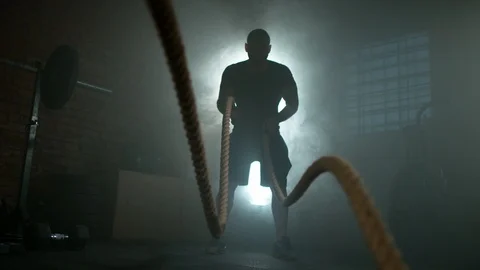 Super slow motion of young man doing exercise with rope Stock Footage 100747389