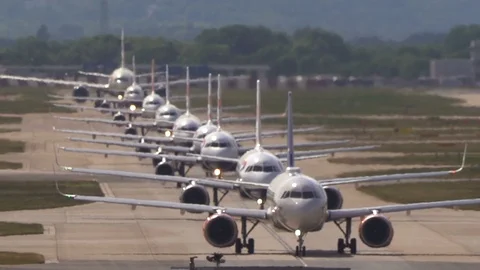 Super-telephoto view of planes queuing on runway with heat shimmer Stock Footage 111522767