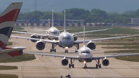 Super-telephoto view of planes queuing for runway with heat shimmer v4 Stock Footage 111523610