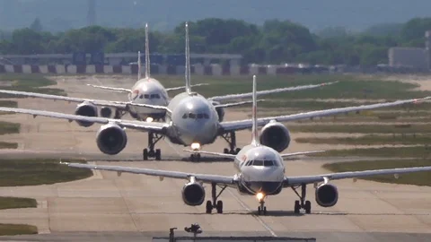 Super-telephoto view of planes queuing on runway with heat shimmer v5 Stock Footage 111523909