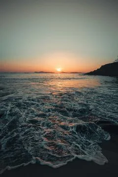 Super textured tides on the beach during a colorful sunset in a spanish beach Stock Photos