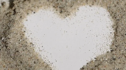 Super tight macro shot of a heart in sand Stock Footage 88050192